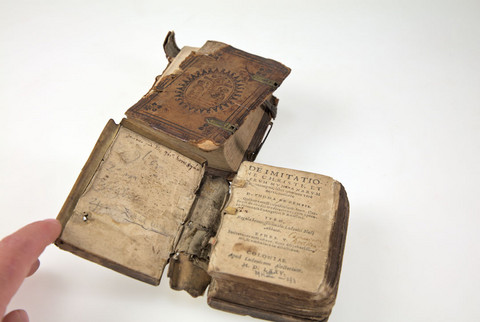 Foto beschädigter Bücher aus dem Jahr 1575: Thomas <von Kempen>: De Imitatione Christi. - Coloniae: Alectorius 1575. Signatur: MKVI41 (2 Exemplare). Die Projektnummer lautet 2022/0027