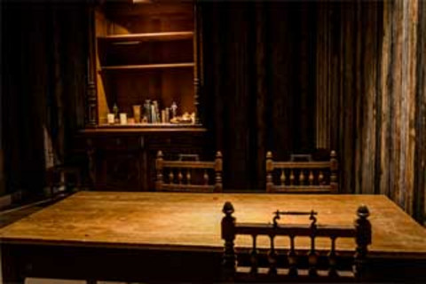 Photo of the dark, historically designed Escape Room.