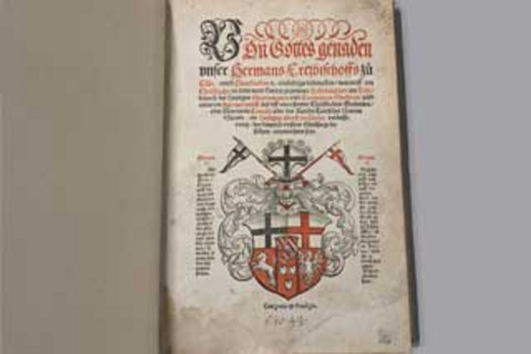 Photo of a title page in black and red.