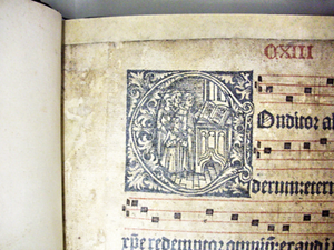 Detailed view of a historical sheet music with a decorated initial.